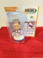 Front angled view of packaged Patrick Roy bobblehead