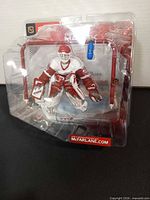 Front angle of sealed McFarlane Dominik Hasek figure with accessories visible