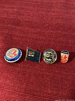 Group shot of all four Labatt pins aligned
