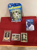 Overview of all items: three Joe DiMaggio cards, Mariano Rivera Play Makers figure, 1999 Yankees TV schedule