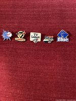 Group image of all five Labatt and Toronto Blue Jays enamel pins