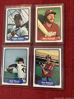 Front view of four 1982 Fleer baseball cards in sleeves showing player photos and names
