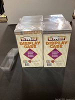 Four Big Bear display case boxes shrink-wrapped, small clear rectangular protectors alongside