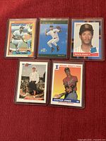 Front views of five rookie cards in hard sleeves