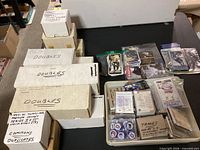 Overview of boxes of hockey cards, tray with sleeved cards and discs