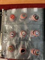 Binder page showing multiple red Budweiser NFL logo bottle caps