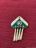 Front of pin showing enamel design, Legion crest, Blue Jays logo, and dangling bats