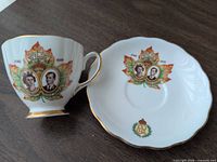 teacup and saucer front showing royal portraits and maple leaf design
