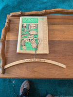 Catalog cover and wooden hanger on table