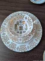 teacup on saucer and dessert plate showing pattern and gilding