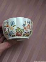 Exterior view showing floral and butterfly design around bowl
