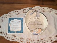 Figurine and certificate on lace mat