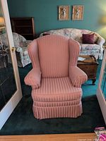 Front view of one pink striped wingback chair