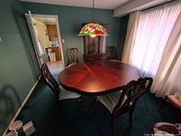 Dining set showing table and four chairs in room
