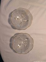 Top view of both clear glass hobnail bowls showing size match and gold-trimmed scalloped edges