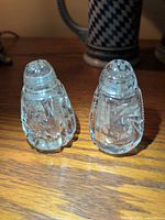 Front view of both matching diamond-cut crystal shakers