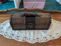Closed chest-style display box on table, showing exterior