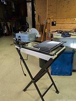 Overall view of wet tile saw mounted on foldable stand