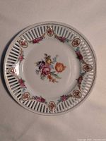 Top view showing full design, pierced rim, floral decals