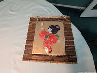 Full view of collage on bamboo frame with hanging cord
