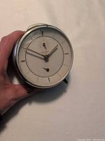 Front view of Junghans alarm clock showing dial and hands