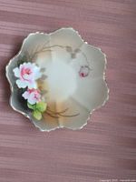 Top view showing floral design, scalloped rim and gold edging
