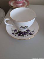 Purple violets cup and saucer showing pattern and gold trim