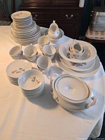 Overall view of stacked plates, bowls, cups, gravy boat and tureen