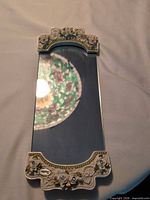 Full view of mirror tray showing ornate ends and mirror surface