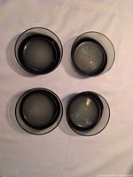 Top view showing four smoky black glass bowls