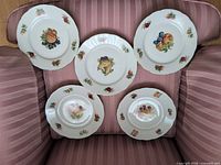 All five fruit-decorated dessert plates displayed