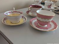 Three teacup and saucer sets side by side