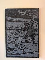 Full view of carved stone panel depicting Inuit hunter