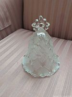 Front view of crystal bell showing scallop pattern and star handle