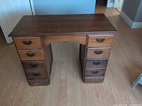 Front view showing six drawers and kneehole
