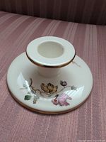 Top view of Wedgwood candlestick showing shape, floral decoration, and gold trim