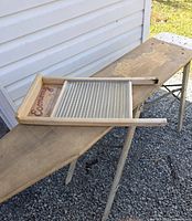 Ironing board set up with washboard on top