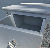Drawer open showing interior and glass knob
