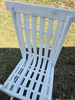 front view of white slat-back rocking chair