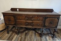 front view of sideboard showing drawers, doors, legs