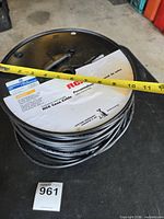 Spool of RCA RG6 coax cable, tape measure across showing diameter