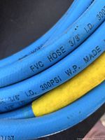 Blue 3/8" I.D. 300 PSI air hose with yellow sleeve