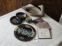 Overall view of lot with duck bowl, pottery, mirrors and plaques