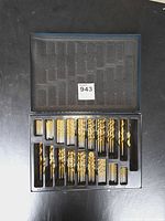 Open case showing organized titanium drill bits and foam lid