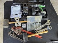 Overall lot showing drill set, wrenches, mallets, pins