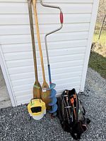 Group shot of auger, paddles, bucket and bag with contents