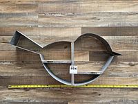 Full view of bird-shaped galvanized metal and wood wall shelf with measuring tape for scale