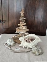 Overall view of driftwood tree, ceramic shell planter with shells, stone frog and turtle figurines