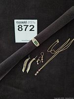 Overview of all jewellery items: ring, necklace, two earring pairs