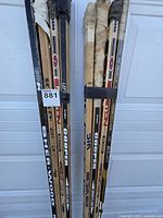 Two strapped bundles of player sticks showing brands and left-hand orientation